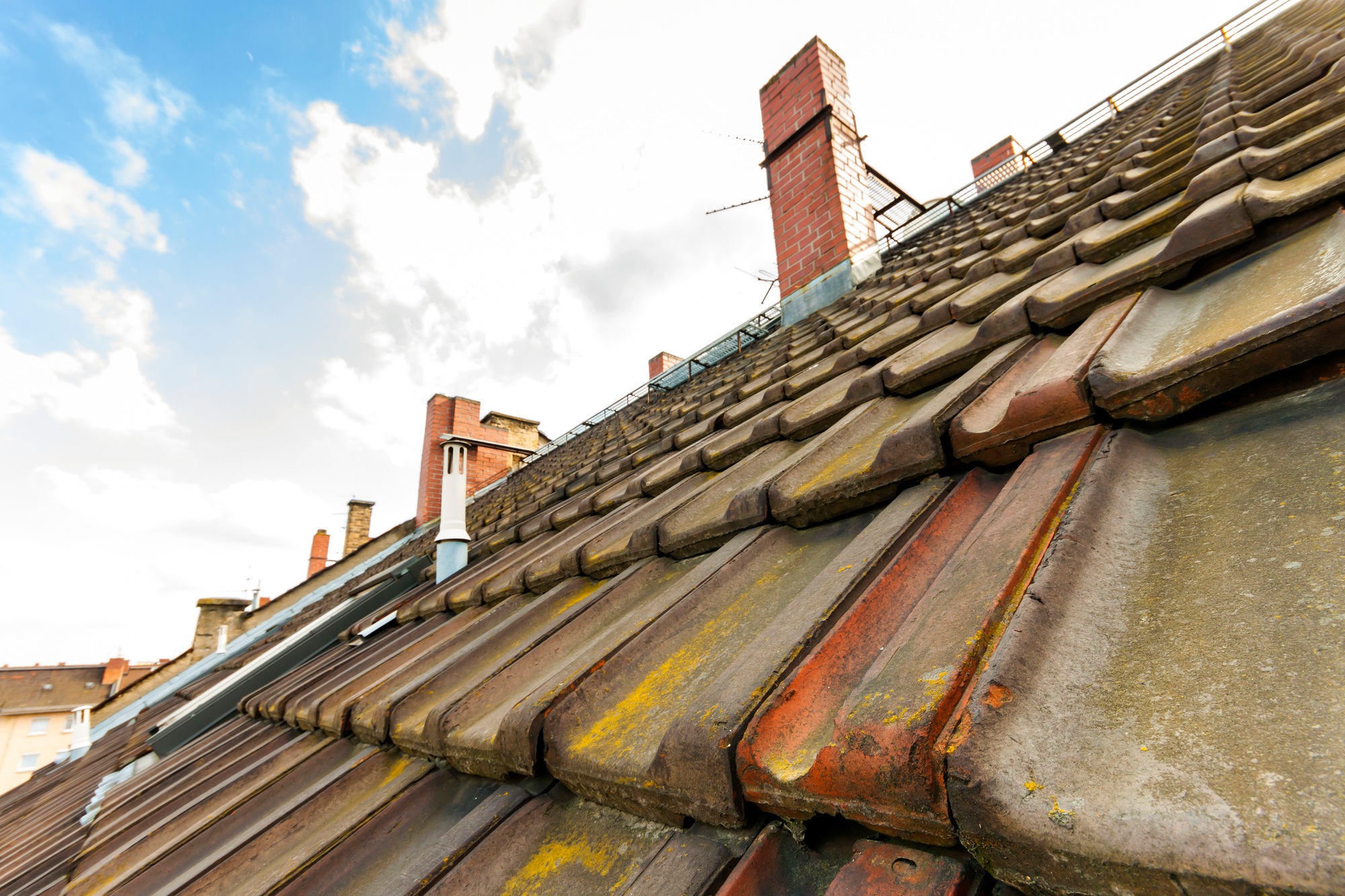 Old roof with roofing tiles and chimneys